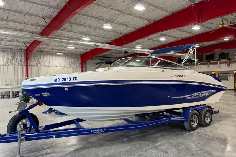 The Image of 2006 Rinker 246 boat on trailer in indoor storage facility. - 1
