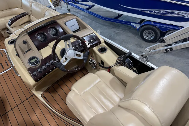 Slide: The Image of 2011 Bennington 2575 RCW I/O boat interior with steering wheel and control panel. - 11