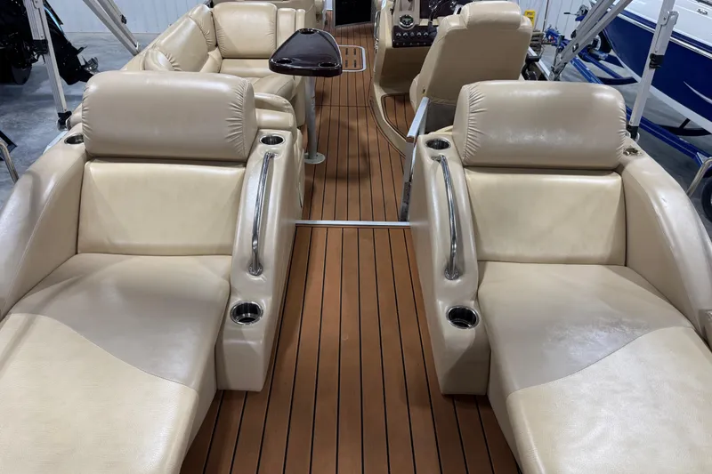 Slide: The Image of Luxurious interior of 2011 Bennington 2575 RCW I/O boat with beige seating and wood flooring. - 12