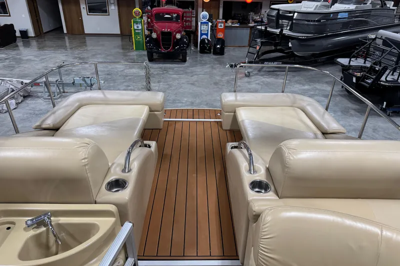 Slide: The Image of 2011 Bennington 2575 RCW I/O boat interior with beige seating and wood-style flooring. - 14