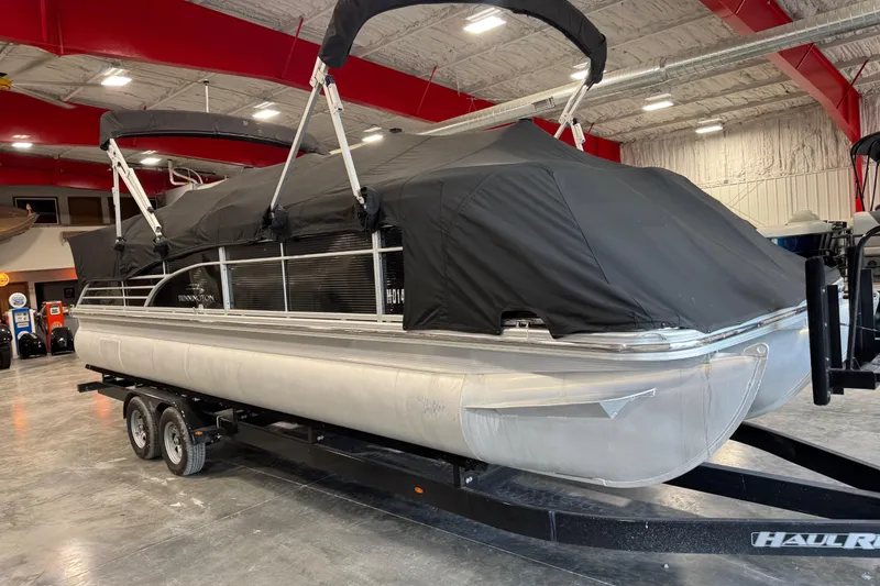 Slide: The Image of 2011 Bennington 2575 RCW I/O pontoon boat with black cover on trailer indoors. - 15