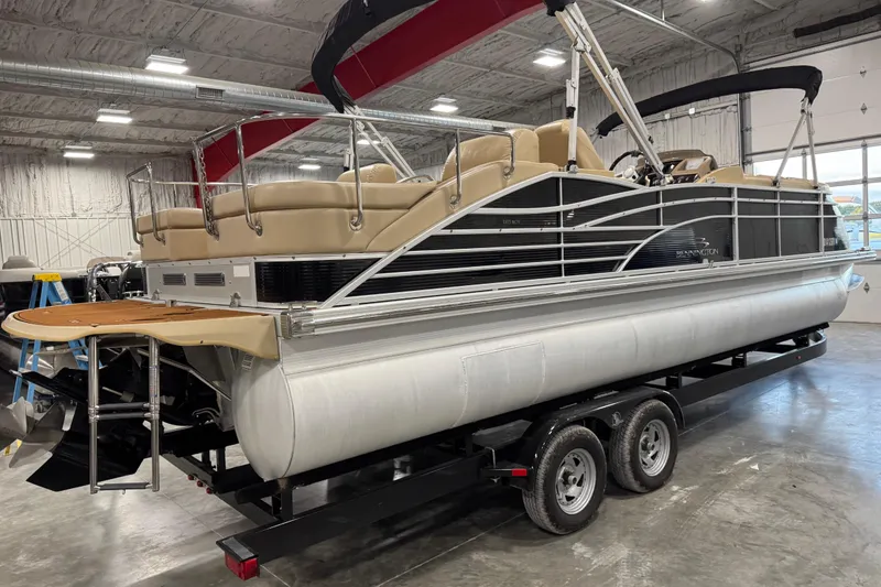 Slide: The Image of 2011 Bennington 2575 RCW I/O pontoon boat on trailer in indoor storage facility. - 5