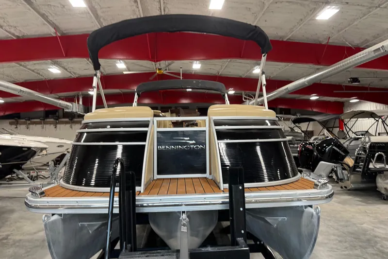 Slide: The Image of 2011 Bennington 2575 RCW I/O boat in showroom, featuring sleek design and modern amenities. - 6