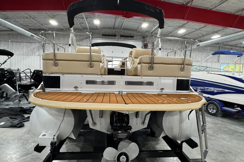 Slide: The Image of 2011 Bennington 2575 RCW I/O pontoon boat in a showroom, rear view. - 7