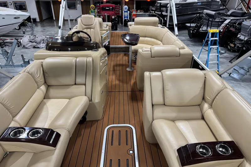 Slide: The Image of 2011 Bennington 2575 RCW I/O pontoon boat with luxurious beige seating and wood-style flooring. - 8