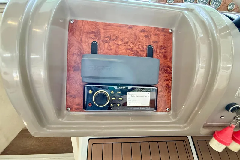 Slide: The Image of 1998 Regal Commodore 402 dashboard with Fusion stereo system and wood paneling. - 10