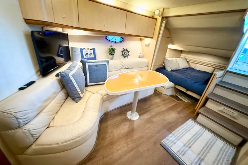 Slide: The Image of Interior of 1998 Regal Commodore 402 yacht with cozy seating and sleeping area. - 13