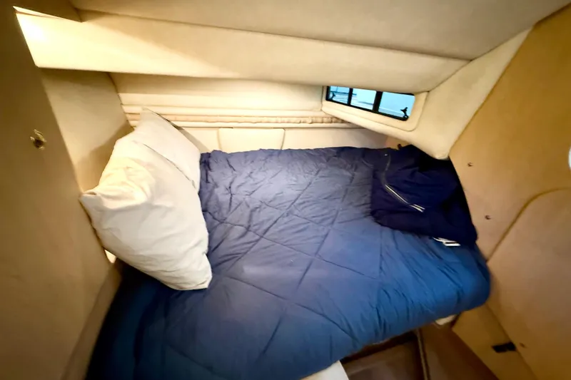 Slide: The Image of Cozy cabin bed in 1998 Regal Commodore 402 yacht with blue bedding. - 15