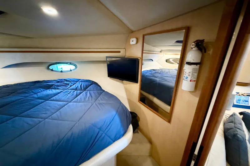 Slide: The Image of Interior of 1998 Regal Commodore 402 yacht with bed, mirror, and TV. - 18