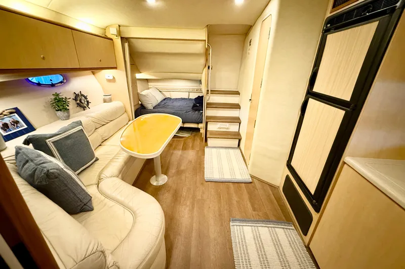 Slide: The Image of Interior of 1998 Regal Commodore 402 yacht with cozy seating and modern amenities. - 22