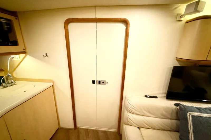 Slide: The Image of Interior of 1998 Regal Commodore 402 yacht with kitchenette and seating area. - 23