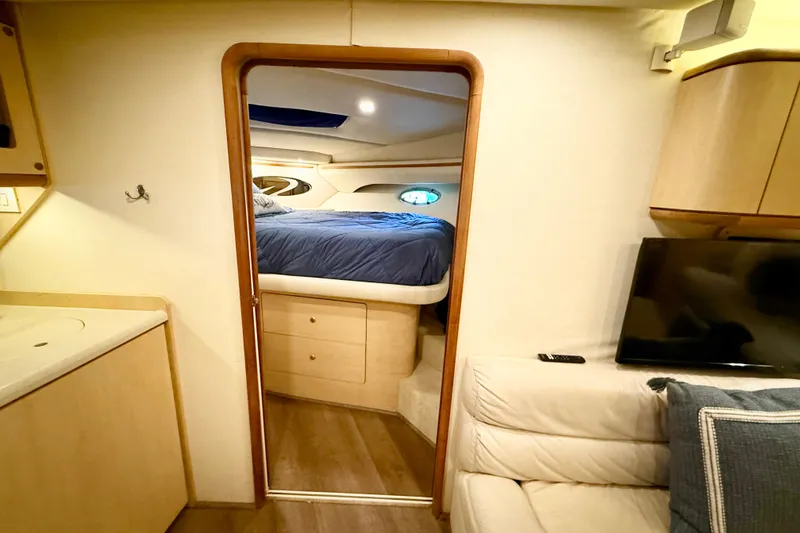 Slide: The Image of Interior of 1998 Regal Commodore 402 yacht, featuring cozy bedroom and modern amenities. - 24