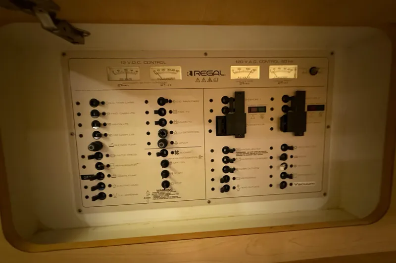 Slide: The Image of Electrical control panel of 1998 Regal Commodore 402 boat, featuring various switches and gauges. - 25