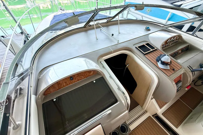 Slide: The Image of 1998 Regal Commodore 402 yacht cockpit with helm, controls, and wooden accents. - 29