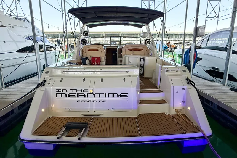 Slide: The Image of 1998 Regal Commodore 402 yacht docked, featuring spacious deck and elegant interior seating. - 3