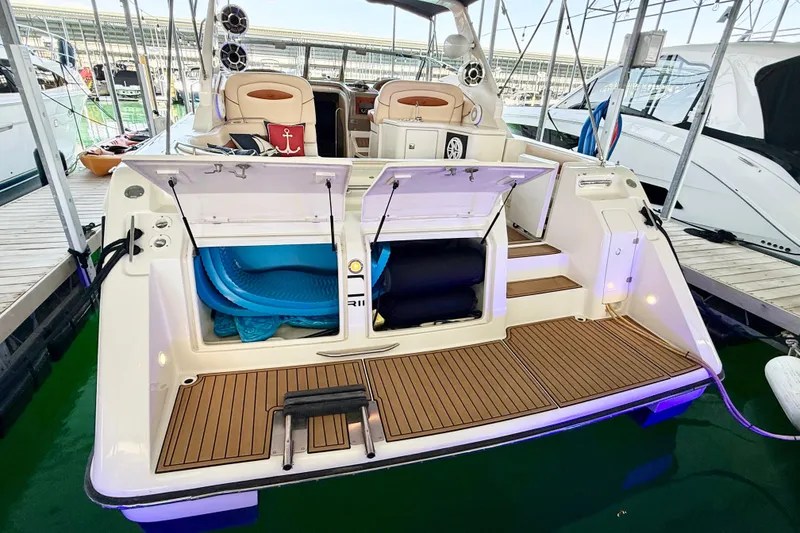 Slide: The Image of 1998 Regal Commodore 402 yacht with open storage compartments at a marina. - 30