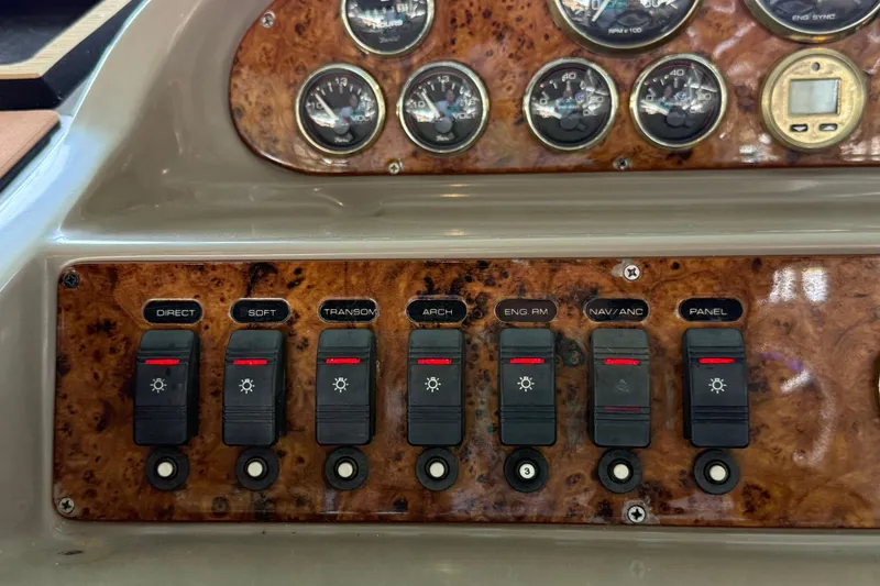 Slide: The Image of Control panel of a 1998 Regal Commodore 402 boat with switches and gauges. - 32