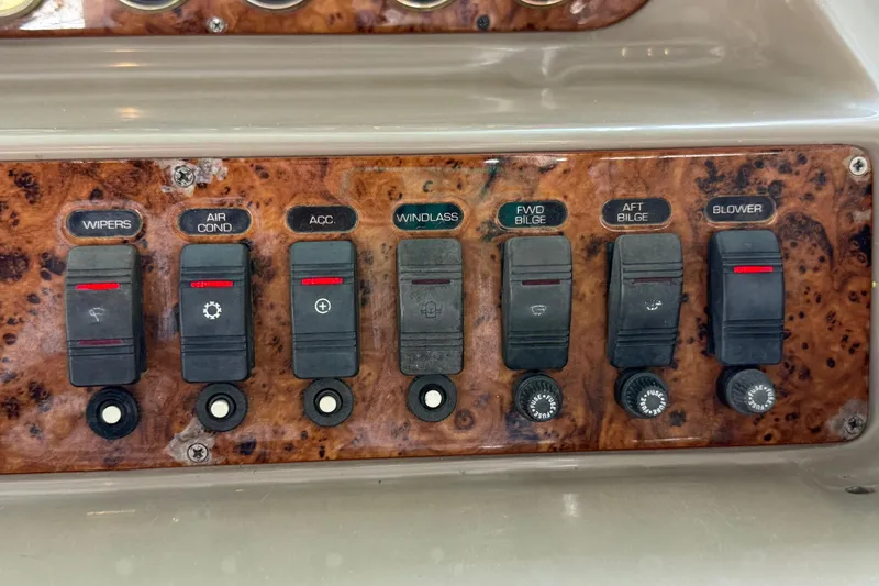 Slide: The Image of Control panel of a 1998 Regal Commodore 402 boat with various switches. - 33