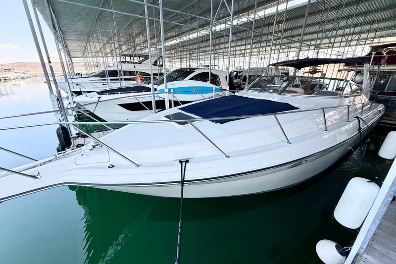 Slide: The Image of 1998 Regal Commodore 402 yacht docked in a marina, featuring sleek white design. - 34