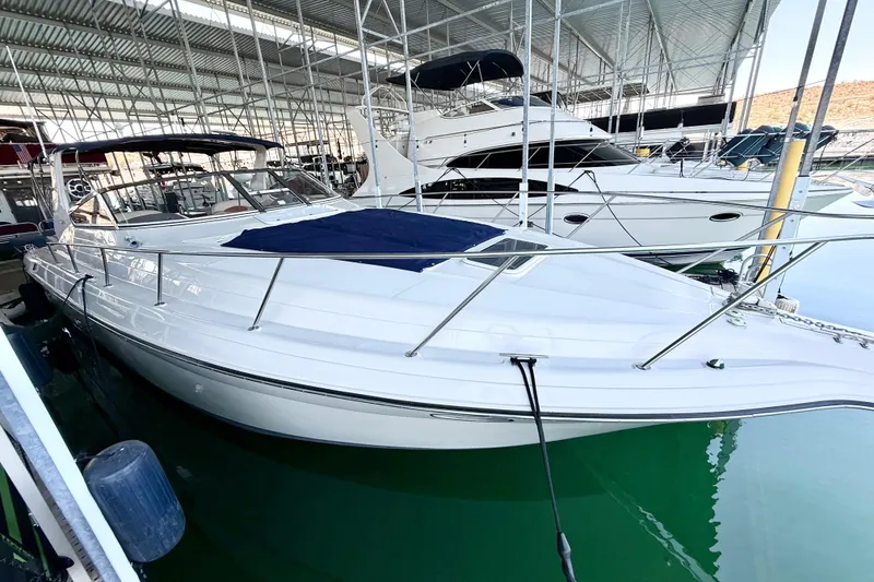 Slide: The Image of 1998 Regal Commodore 402 yacht docked in a marina, featuring sleek white design. - 35