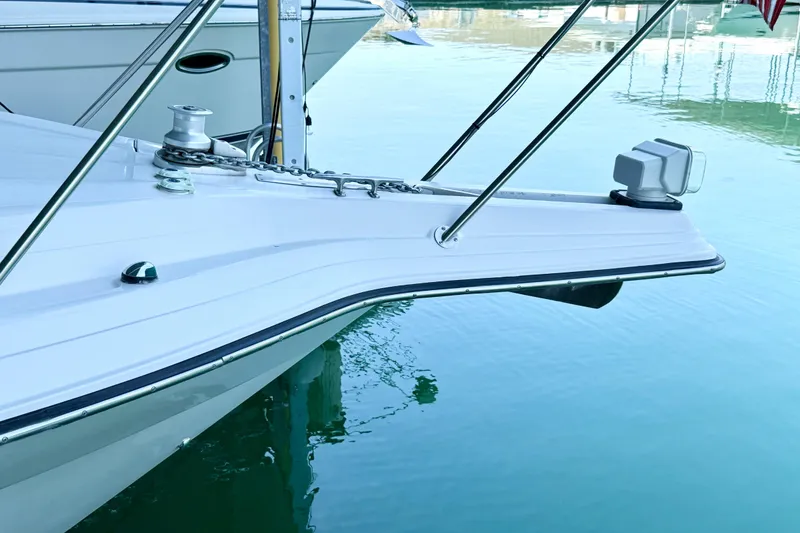 Slide: The Image of Bow of 1998 Regal Commodore 402 yacht in calm marina waters. - 36