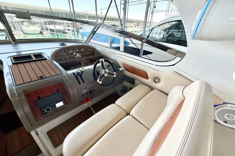 Slide: The Image of 1998 Regal Commodore 402 yacht cockpit with leather seating and modern dashboard controls. - 8