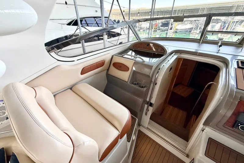 Slide: The Image of Interior of 1998 Regal Commodore 402 yacht with beige seating and wooden accents. - 9