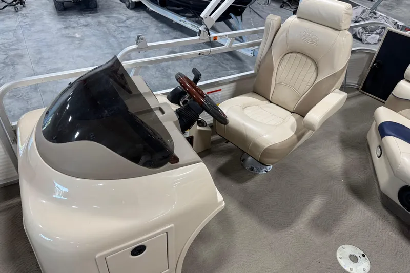 Slide: The Image of 2010 G3 LX3 25 Cruise boat interior with beige captain's chair and steering console. - 10