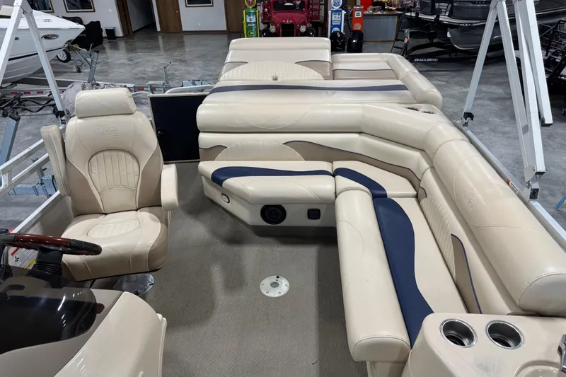 Slide: The Image of 2010 G3 LX3 25 Cruise pontoon boat interior with beige seating and steering console. - 11