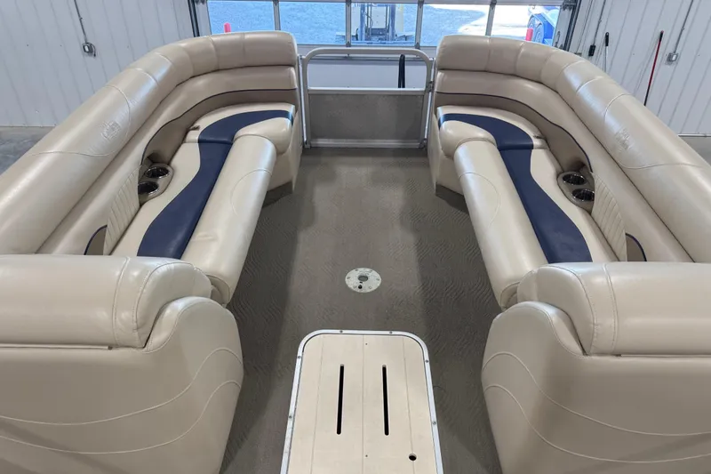 Slide: The Image of 2010 G3 LX3 25 Cruise pontoon boat interior with beige and blue seating. - 12