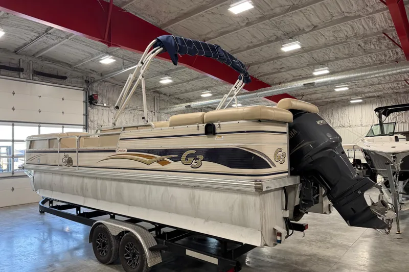Slide: The Image of 2010 G3 LX3 25 Cruise pontoon boat in indoor storage on a trailer. - 3