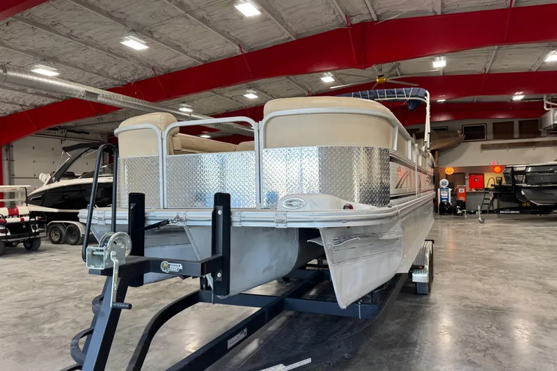 Slide: The Image of 2010 G3 LX3 25 Cruise pontoon boat on trailer in indoor showroom. - 5