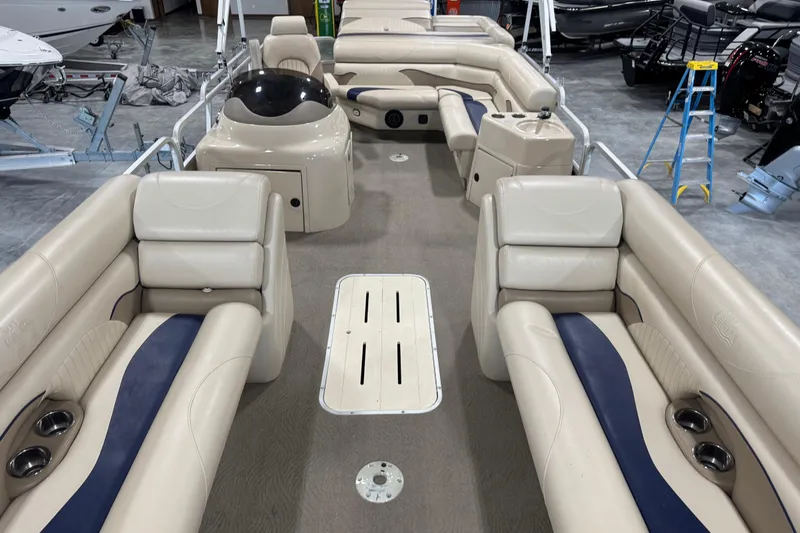 Slide: The Image of 2010 G3 LX3 25 Cruise pontoon boat interior with beige seating and blue accents. - 7