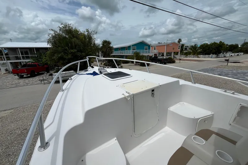 Slide: The Image of 2007 ProKat 2860 Center Console boat docked in a residential area, cloudy sky. - 10