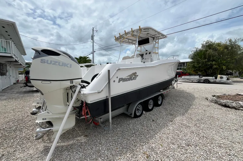 Slide: The Image of 2007 ProKat 2860 Center Console boat with Suzuki engines on a trailer. - 3