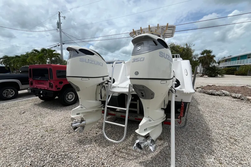 Slide: The Image of 2007 ProKat 2860 Center Console with dual Suzuki 350 outboard engines, parked on gravel. - 4