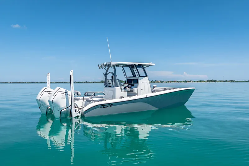 Slide: The Image of 2022 Costa Custom Boats 264 on calm blue water under clear sky. - 11