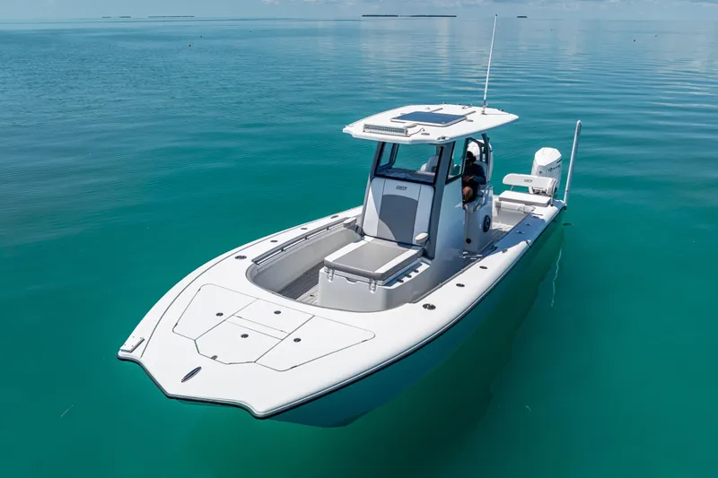 Slide: The Image of 2022 Costa Custom Boats 264 on calm turquoise water, showcasing sleek design and modern features. - 12