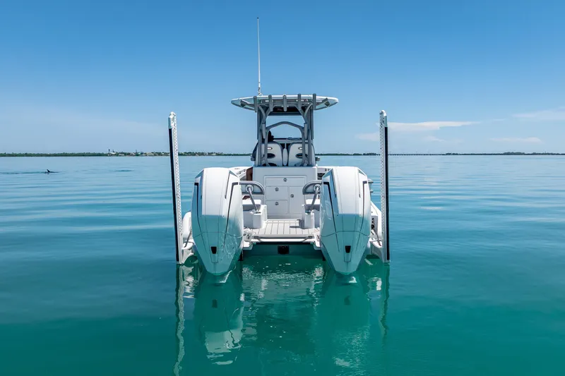 Slide: The Image of 2022 Costa Custom Boats 264 on calm blue water, rear view. - 13