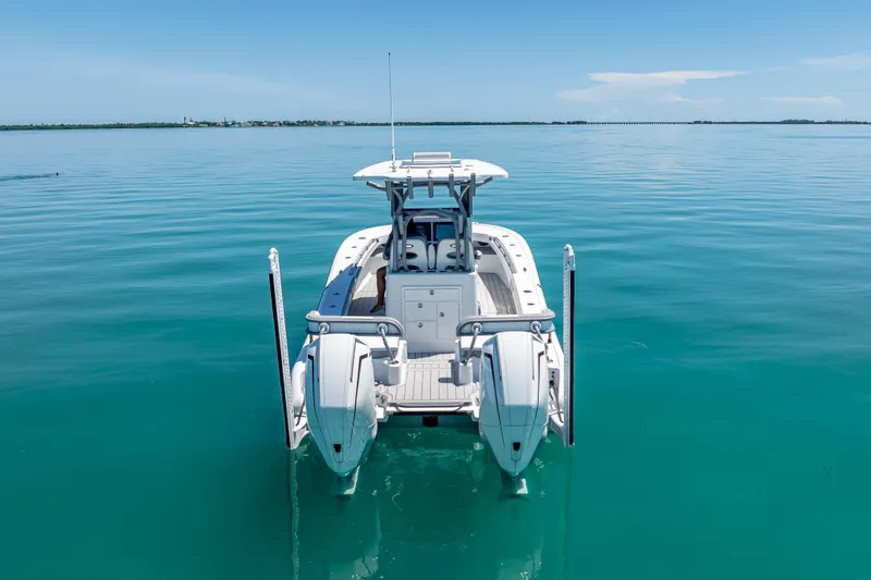 Slide: The Image of 2022 Costa Custom Boats 264 on calm turquoise water, rear view. - 14