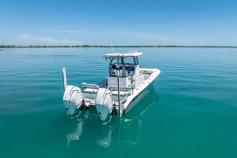 Slide: The Image of 2022 Costa Custom Boats 264 on calm blue water, showcasing twin engines. - 15