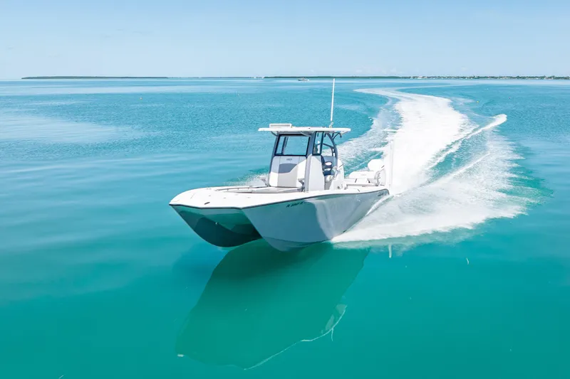 Slide: The Image of 2022 Costa Custom Boats 264 cruising on clear turquoise waters. - 2