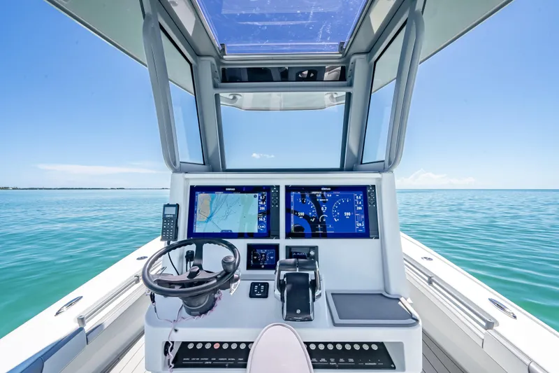 Slide: The Image of 2022 Costa Custom Boats 264 helm with dual displays on open water. - 20