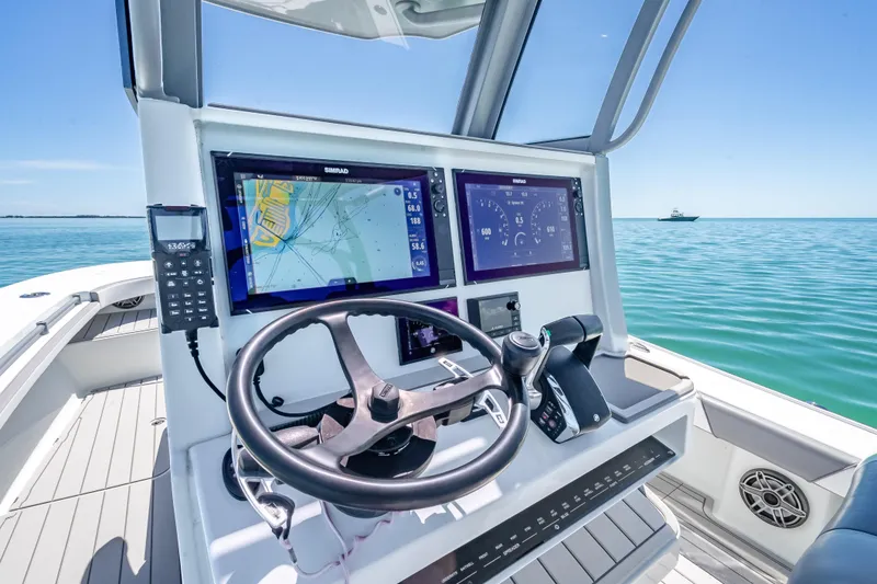 Slide: The Image of 2022 Costa Custom Boats 264 helm with advanced navigation system on open water. - 21