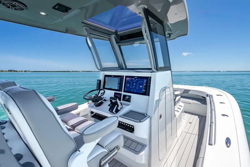 Slide: The Image of 2022 Costa Custom Boats 264 helm with advanced navigation, sleek design, and ocean view. - 25