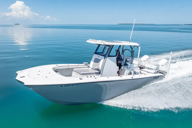 Slide: The Image of 2022 Costa Custom Boats 264 cruising on clear blue water. - 3