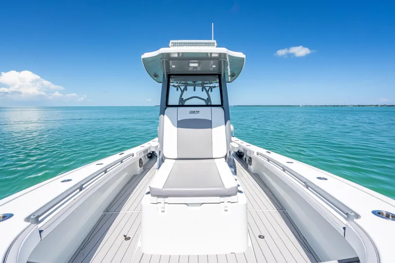 Slide: The Image of 2022 Costa Custom Boats 264 on calm ocean, showcasing sleek design and spacious deck. - 33