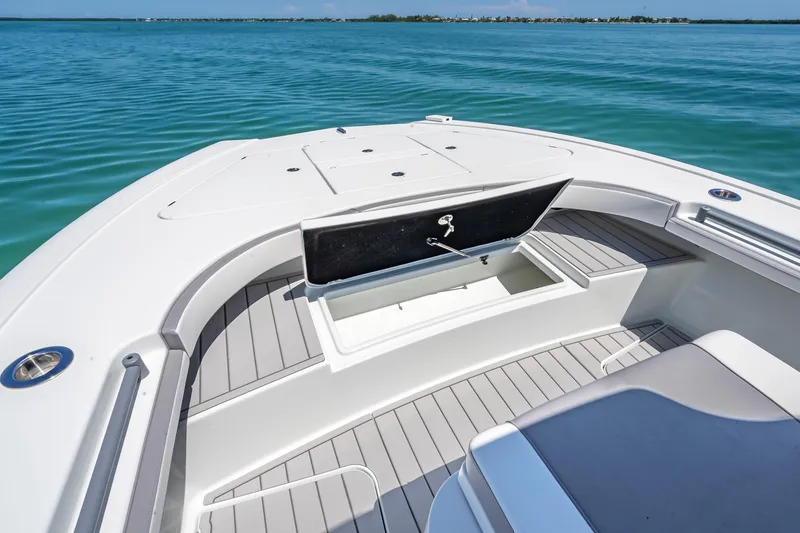 Slide: The Image of 2022 Costa Custom Boats 264 with open storage compartment on calm blue water. - 35