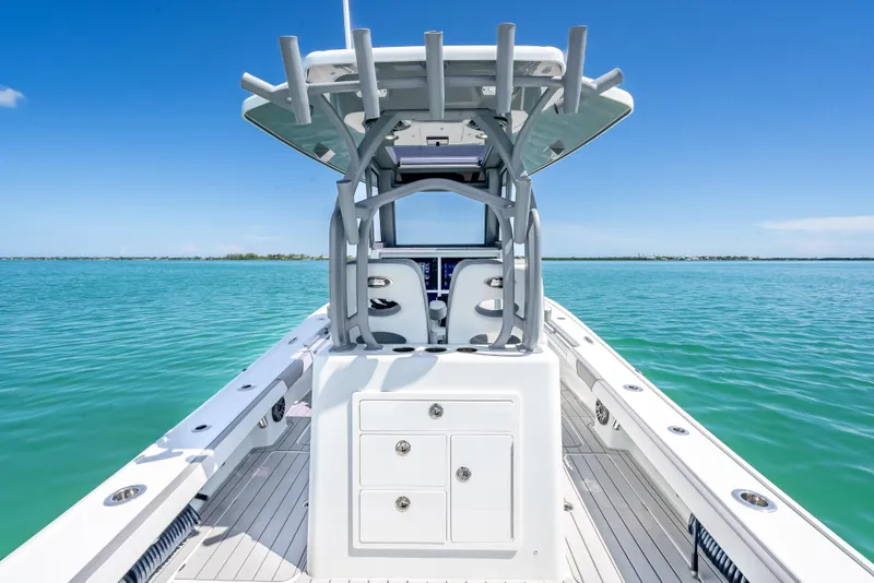 Slide: The Image of 2022 Costa Custom Boats 264 on calm blue water, showcasing sleek design and spacious deck. - 40