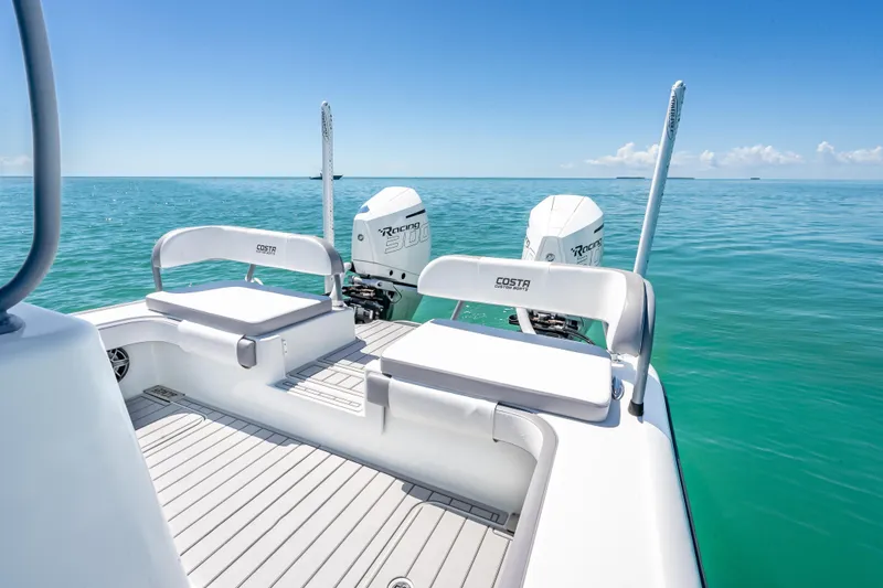 Slide: The Image of 2022 Costa Custom Boats 264 on serene ocean, featuring dual engines and sleek seating. - 43